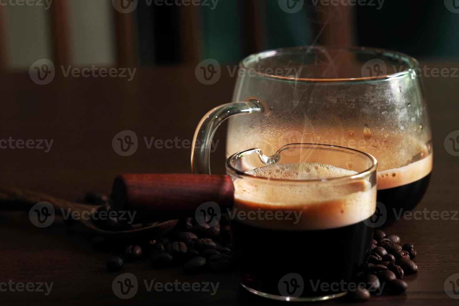 sterke hete koffie met bonen op donkere achtergrond foto