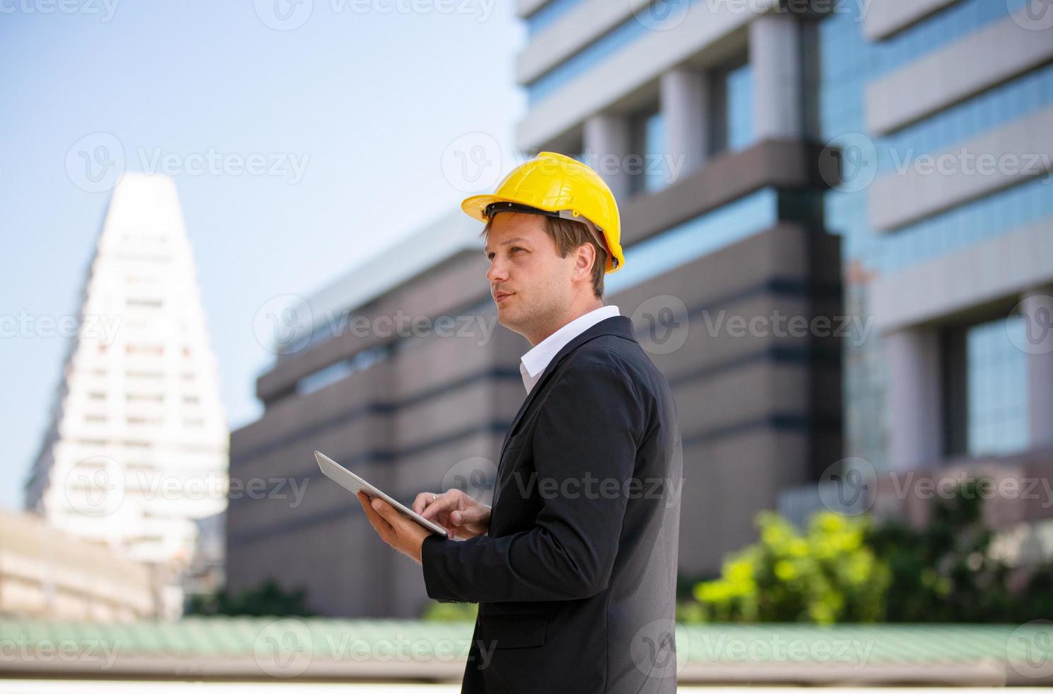 de ingenieur en zakenvrouw die op het klembord controleren bij de bouw van de bouwplaats. het concept van engineering, constructie, stadsleven en toekomst. foto