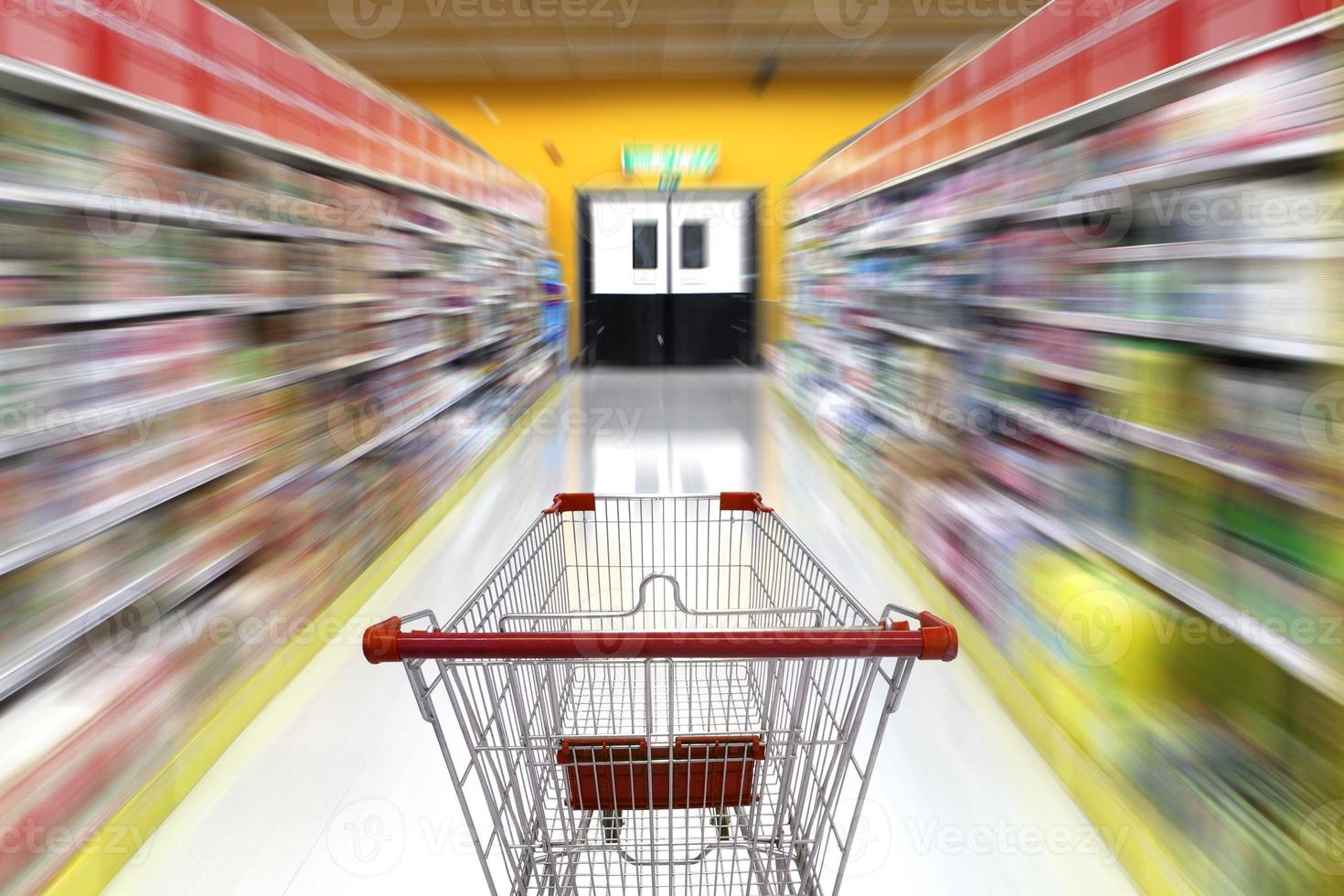 supermarkt gangpad met lege winkelwagen, supermarkt winkel abstracte onscherpe achtergrond met winkelwagen foto
