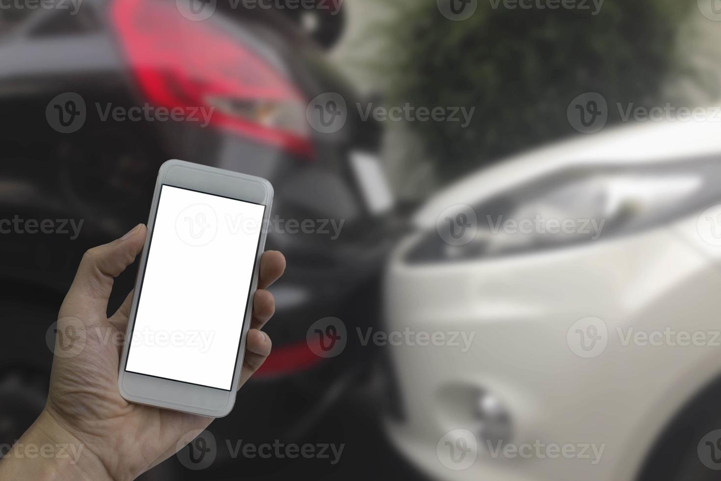 hand met smartphone met wit leeg scherm wazige achtergrond auto-ongelukken foto