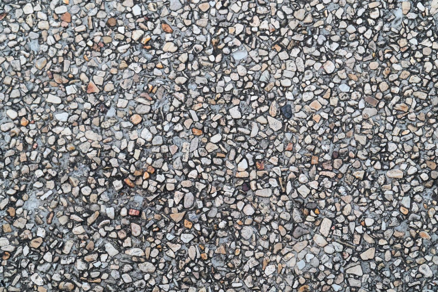 grunge kiezelsteen vloer als naadloze getextureerde background.small kiezelstenen gemengd met zand texted achtergrond. foto
