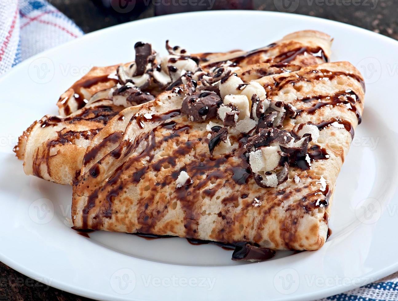 pannenkoeken met chocoladesiroop en pruimen foto