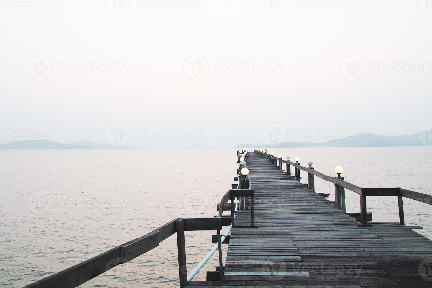 een houten loopbrug die zich uitstrekt in de zee. vakantie reisconcept foto