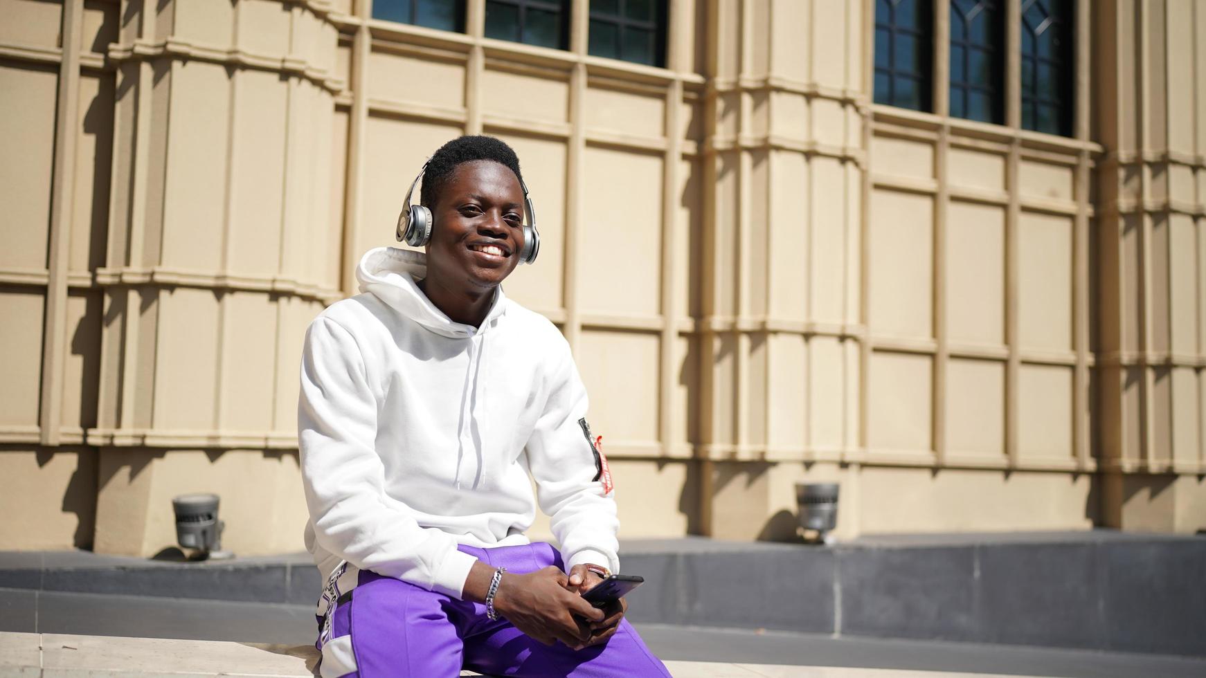 Afro-Amerikaanse man met plezier wandelen in het centrum - gelukkige jonge kerel genieten van tijd een zonsondergang buiten - millennial generatie levensstijl en positieve mensen houding concept foto