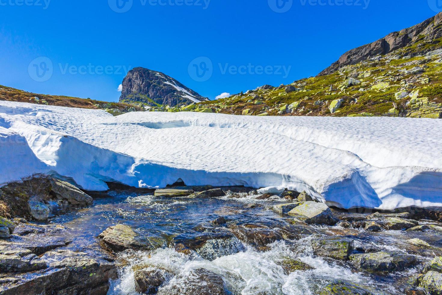 sneeuw in de zomer bij berg storehodn hydnefossen waterval hemsedal noorwegen. foto