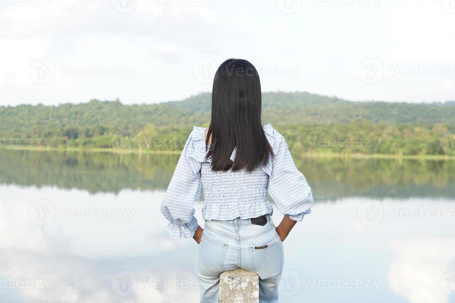 vrouwelijke toerist op de berg die naar de natuur kijkt foto