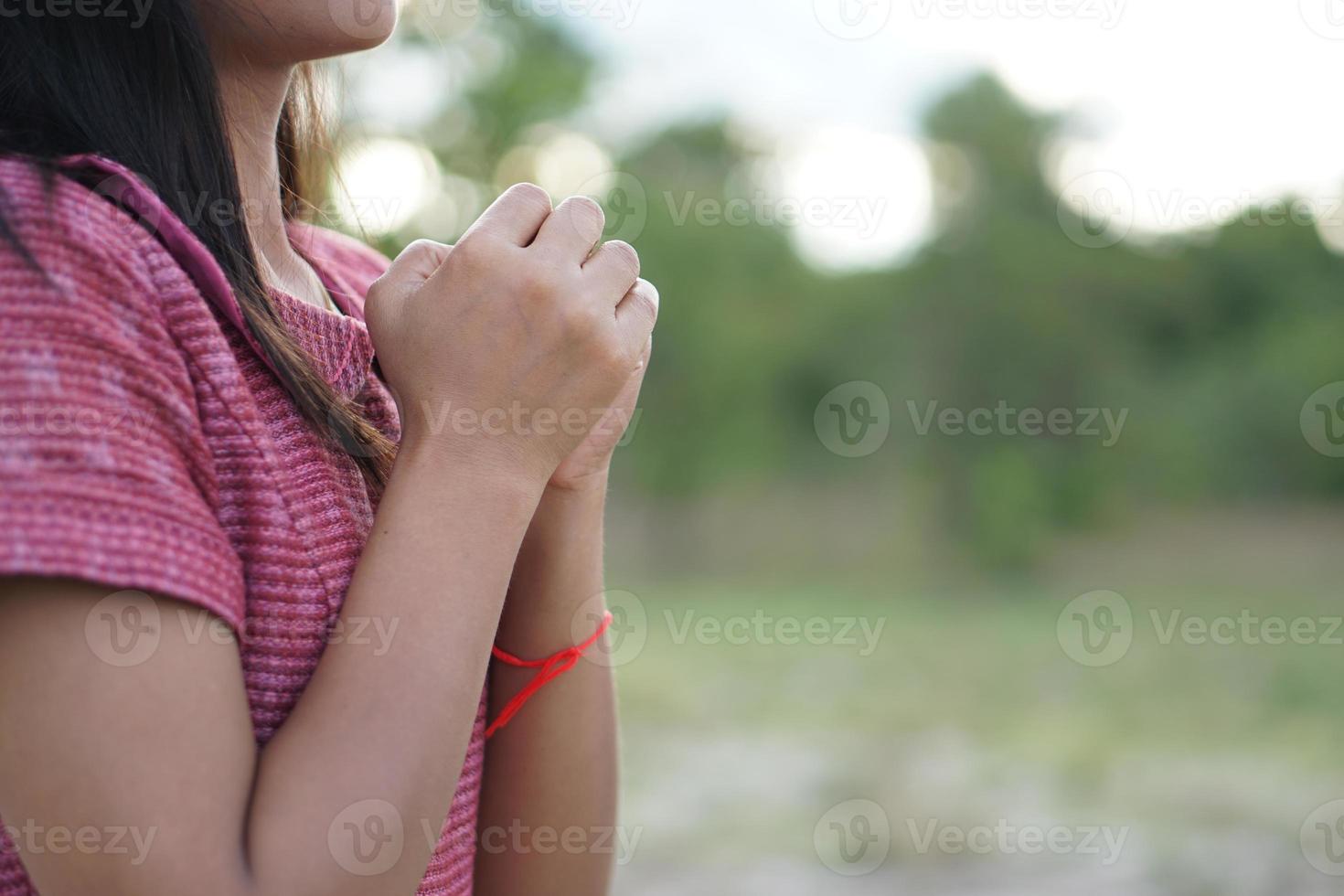 de hand van een aziatische vrouw die om zegeningen vraagt van de achtergrond van de god groene weide foto