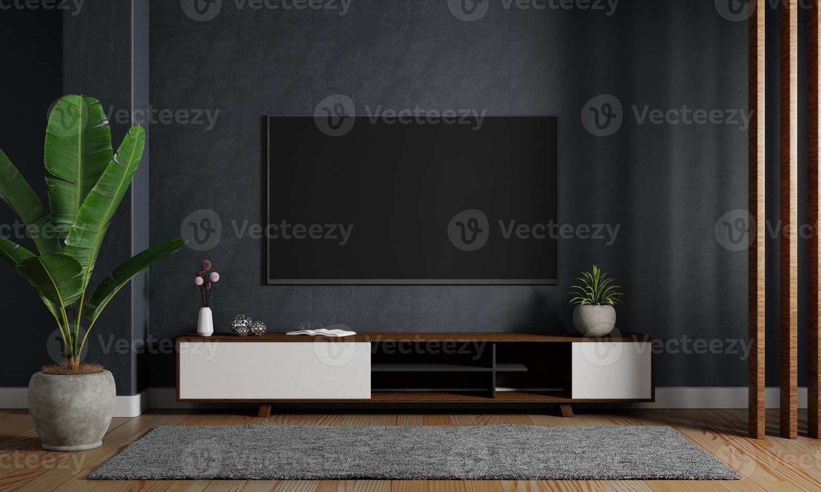 moderne mockup televisie tv hangend aan de donkerblauwe muur achtergrond met houten kast in de woonkamer. interieurarchitectuur en entertainmentconcept. 3D illustratie weergave foto