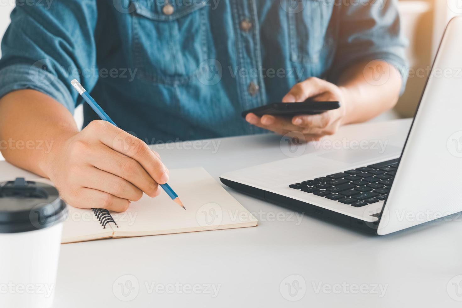 werken met mobiele telefoon typen computer mobiele chat laptop contact met ons opnemen op werkplekken, plannen van ideeën investeerders zoeken op internet, ideeën die mensen verbinden. foto