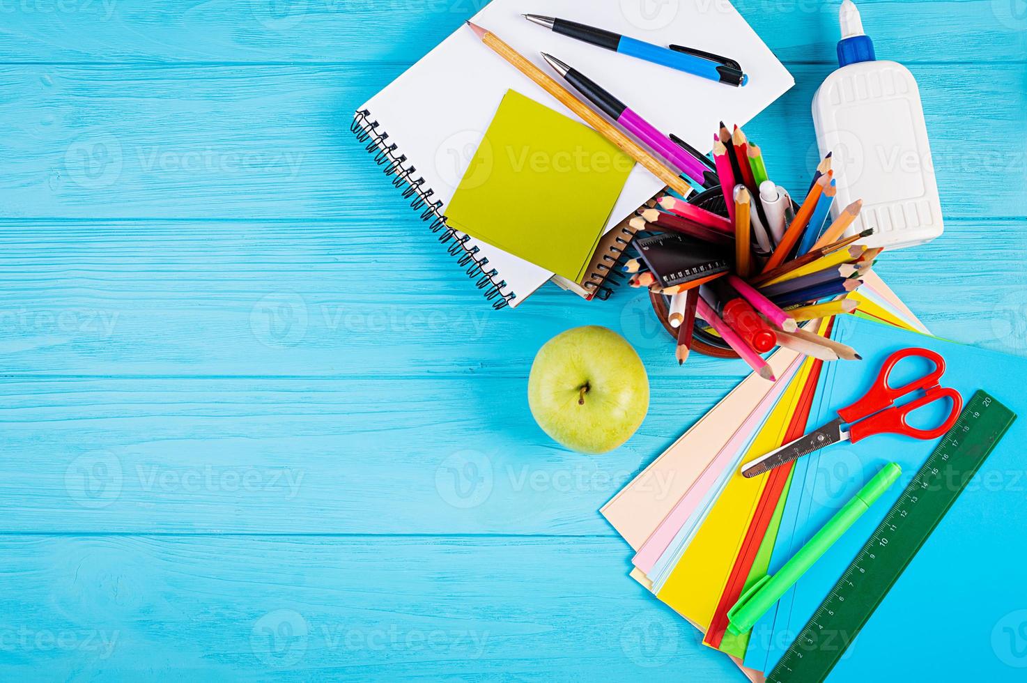 set van kleurrijke schoolbenodigdheden, boeken en notebooks. accessoires voor kantoorbenodigdheden. bovenaanzicht. foto