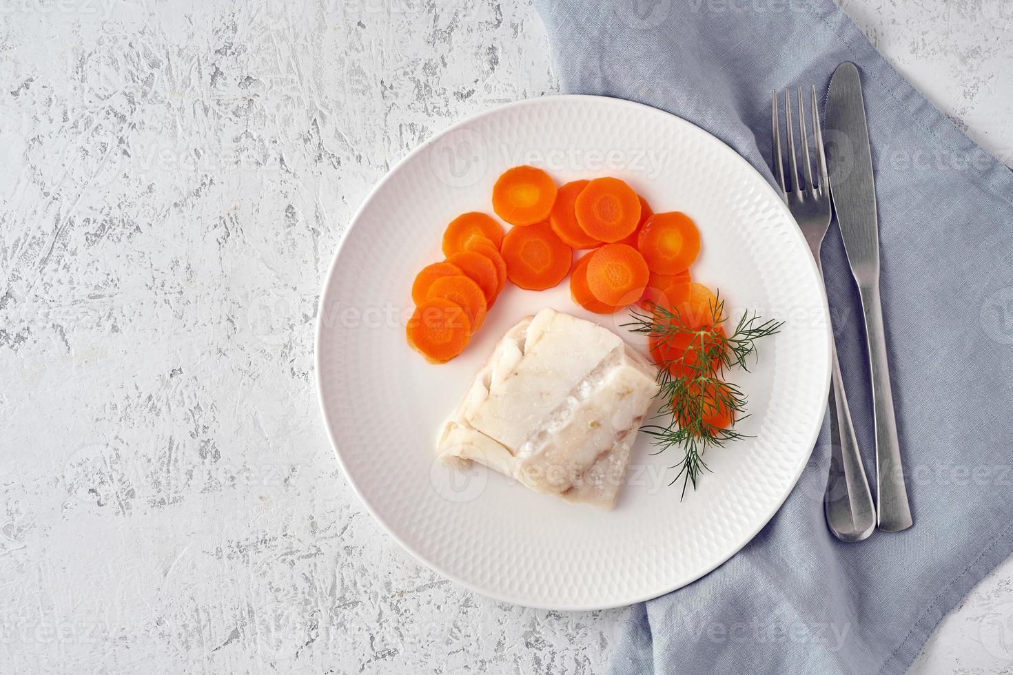 gekookte kabeljauw met wortel en dille op witte plaat, fodmap dash paleo dieet foto