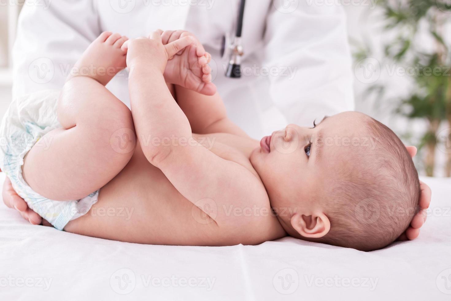 vrouwelijke arts kinderarts met babypatiënt foto