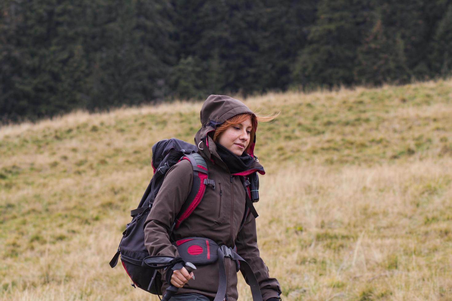 jonge vrouwenwandelaar in de herfstbos foto