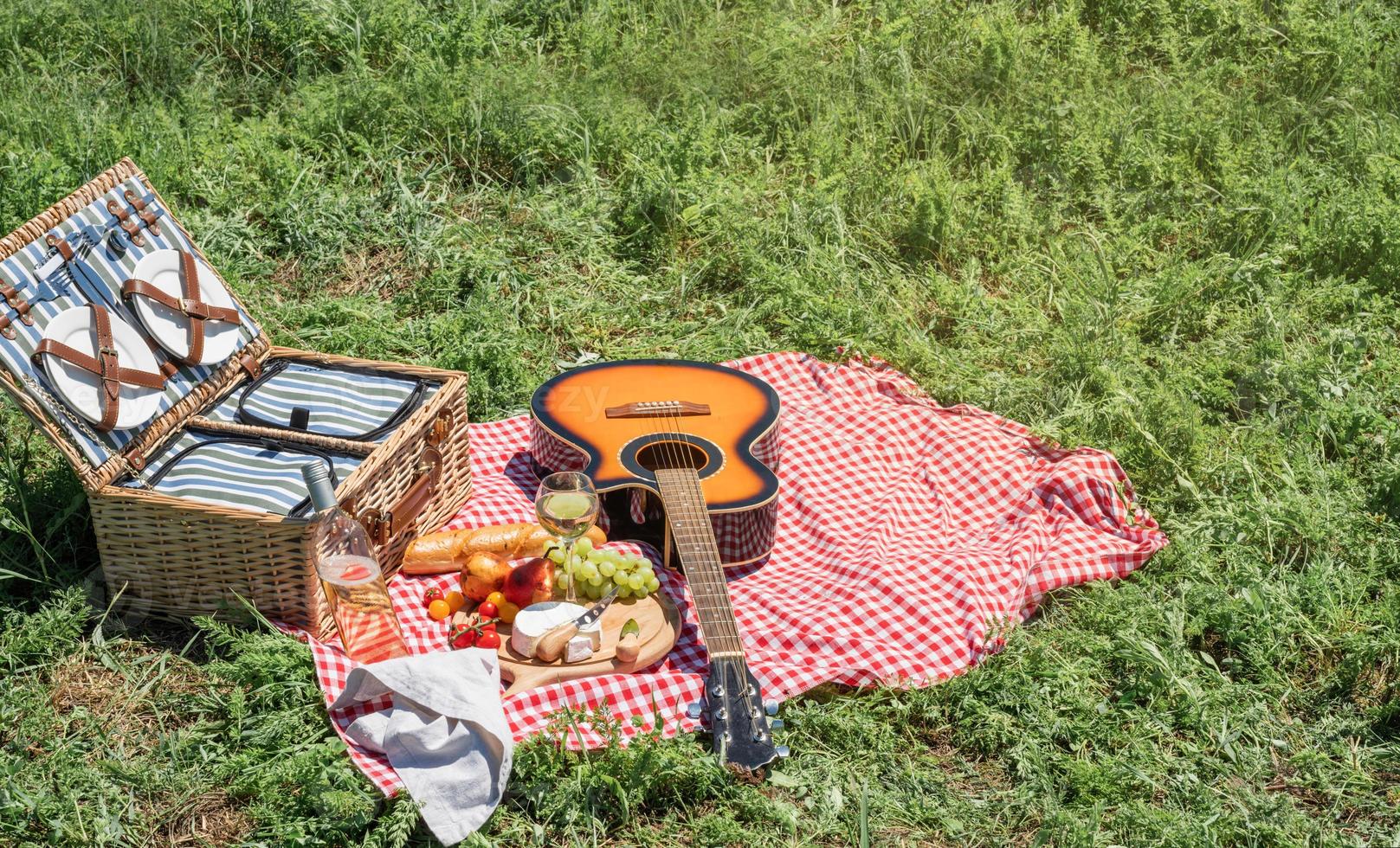 close-up van picknickmand met drankjes en eten op het gras foto