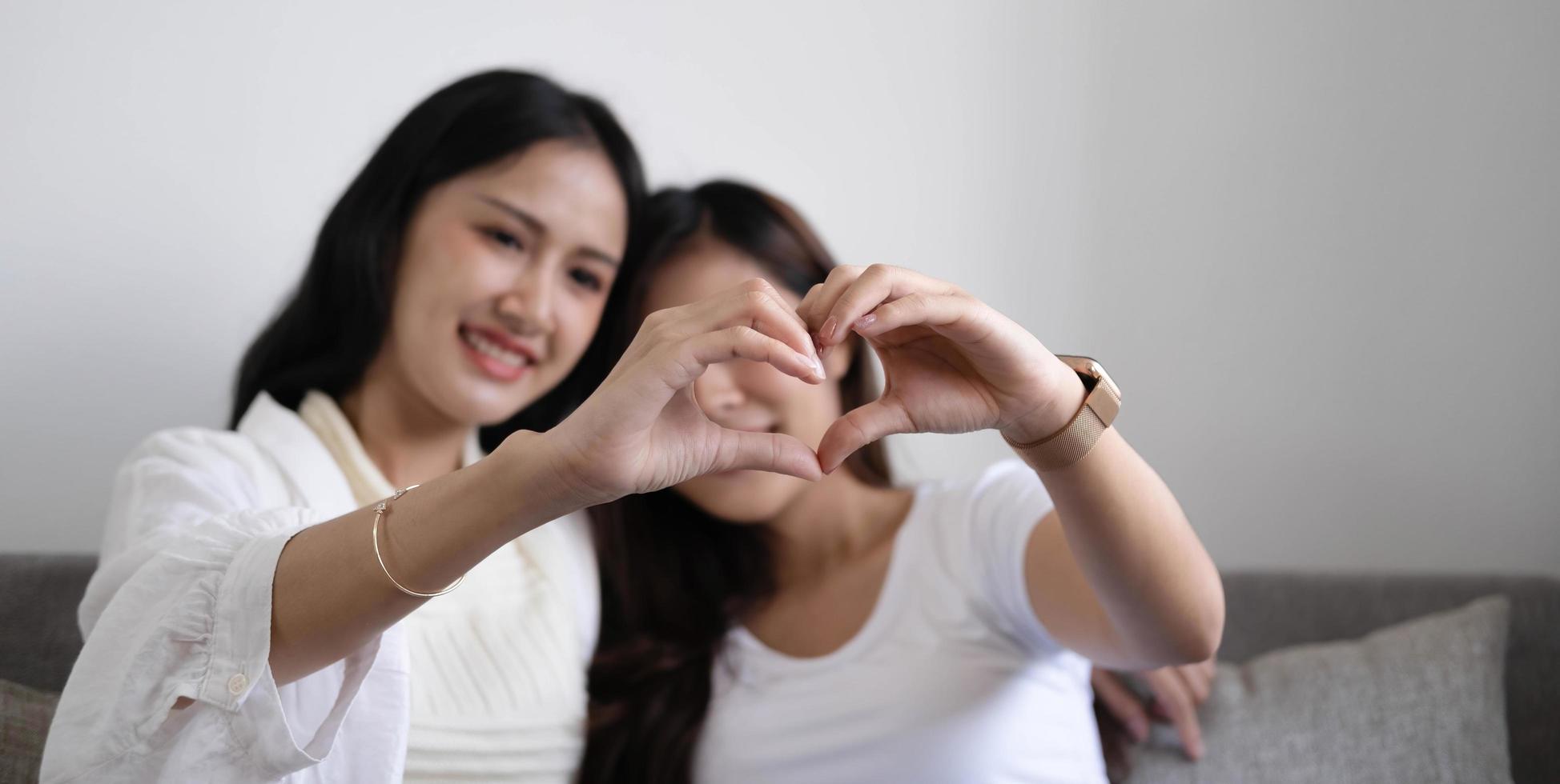 gelukkig lgbt lesbisch koppel hand in hand in de vorm van een hart. foto