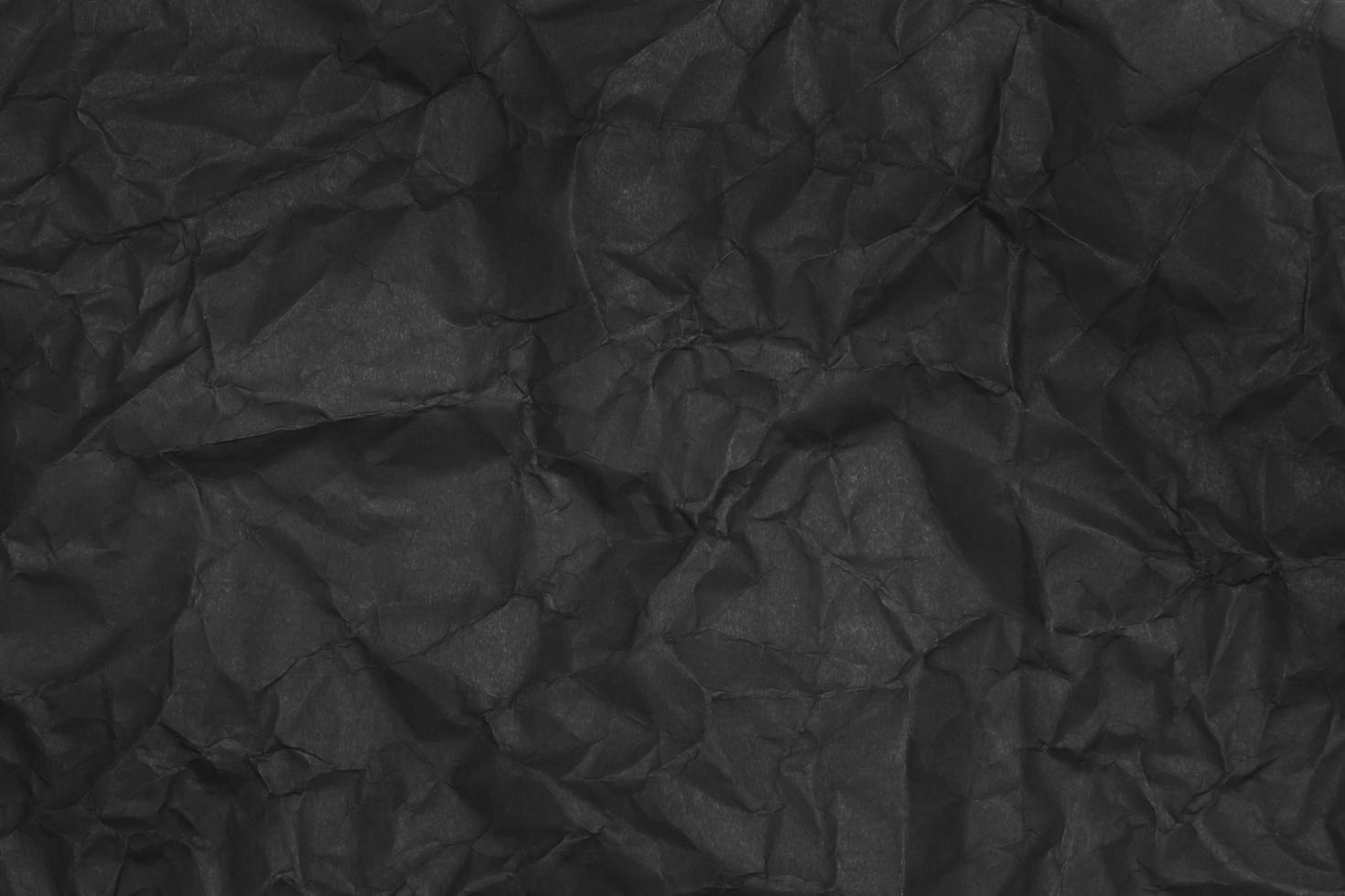zwarte verfrommeld papier textuur als achtergrond foto