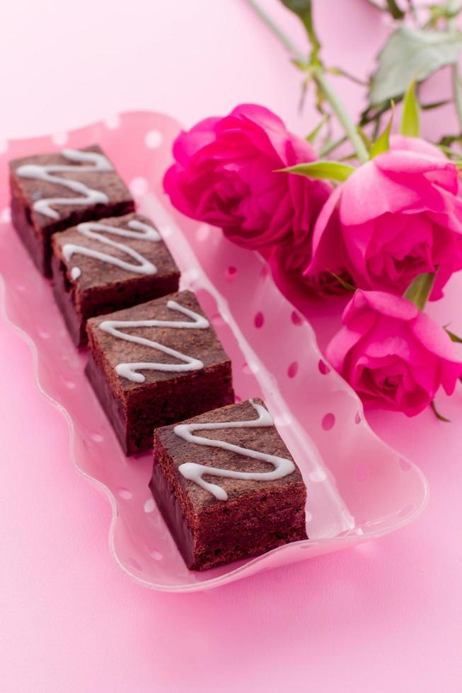 zoete heerlijke brownies op roze achtergrond foto