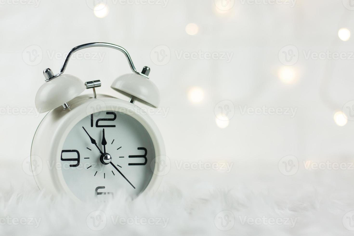 kerst retro alarm clock.decoratied met geschenkdoos en spar feestelijk op wazig bokeh background.celebration en gelukkig nieuwjaar concept. foto