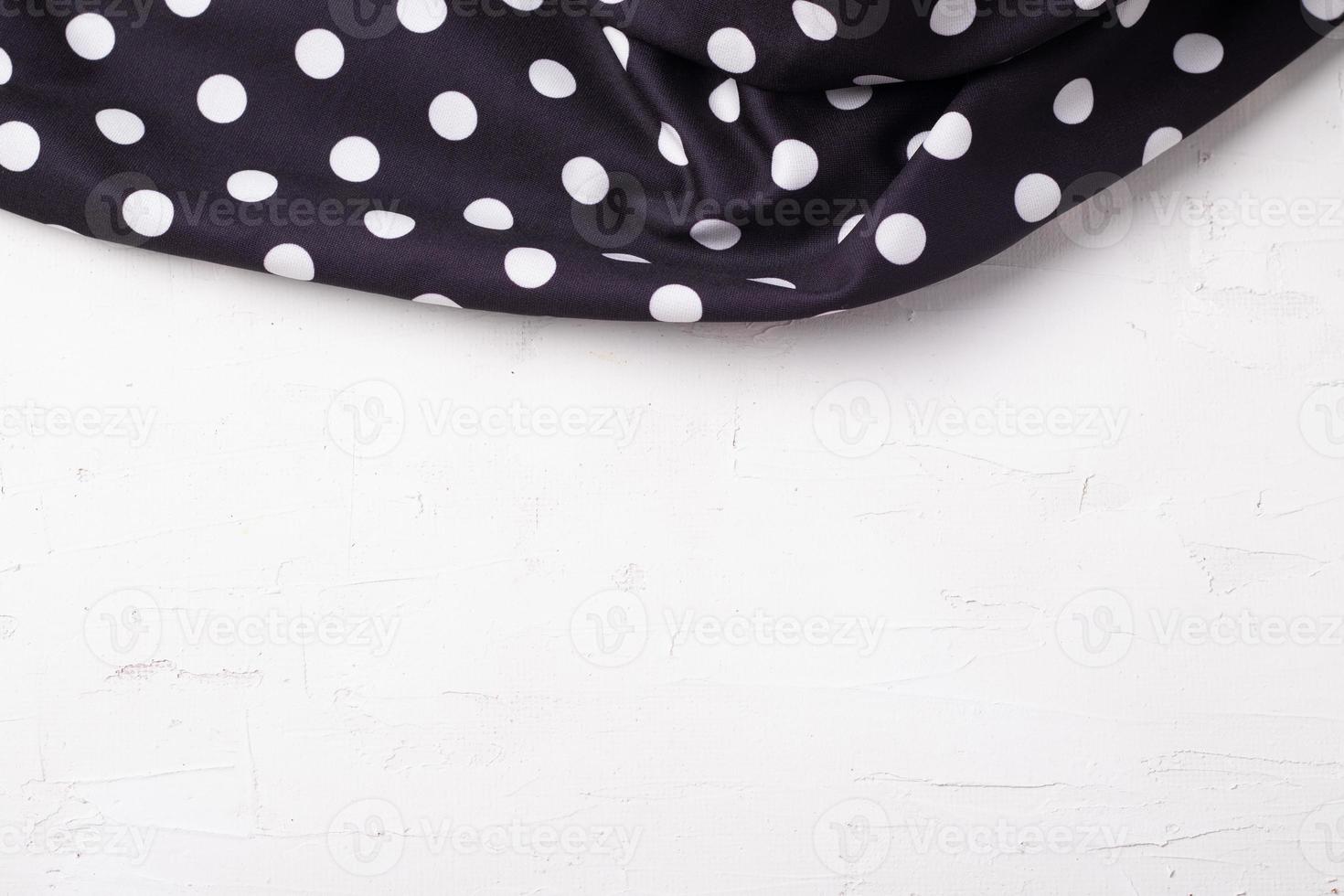 polka dot zwart servet op een houten keukentafel van bovenaf gezien met kopieerruimte foto