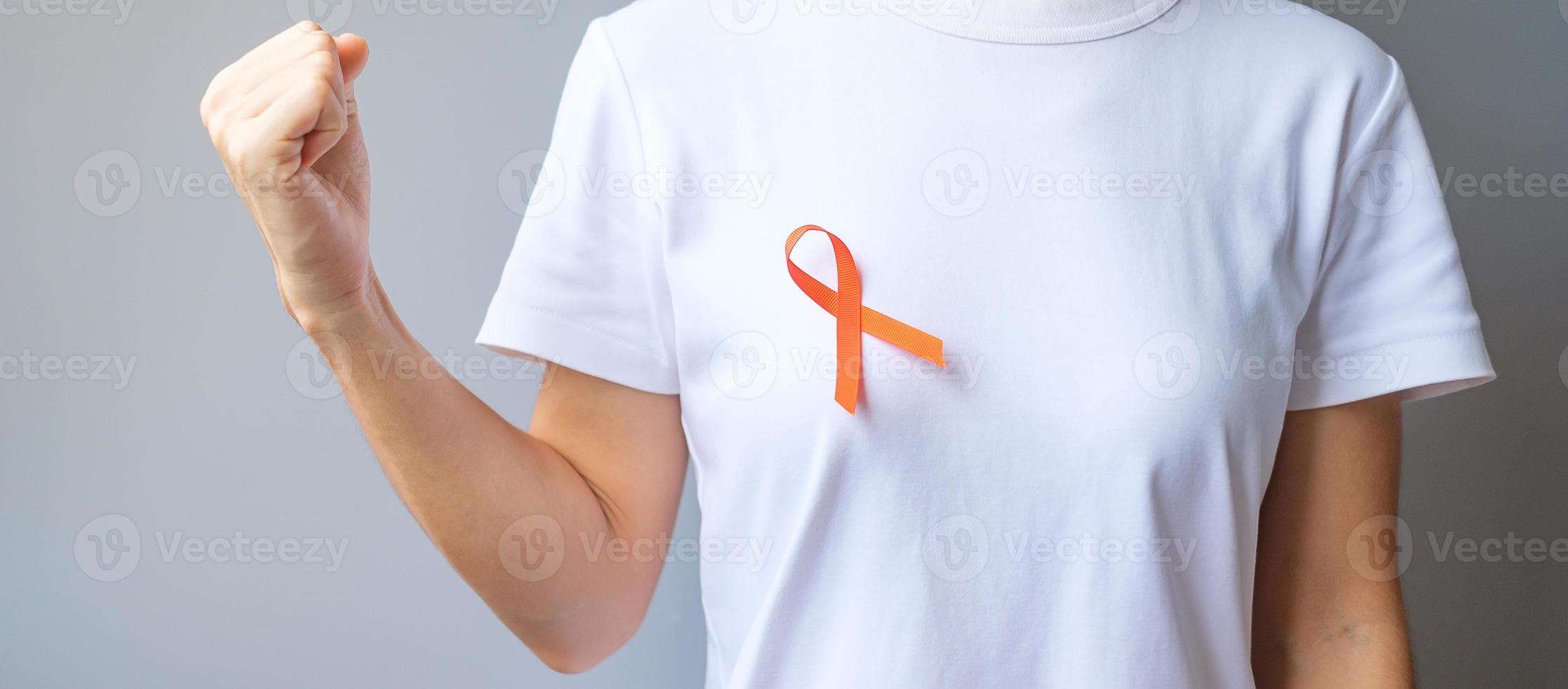 oranje lint voor leukemie, nierkankerdag, wereld multiple sclerose, crps, zelfverwondingsmaand. gezondheidszorg en woord kanker dag concept foto