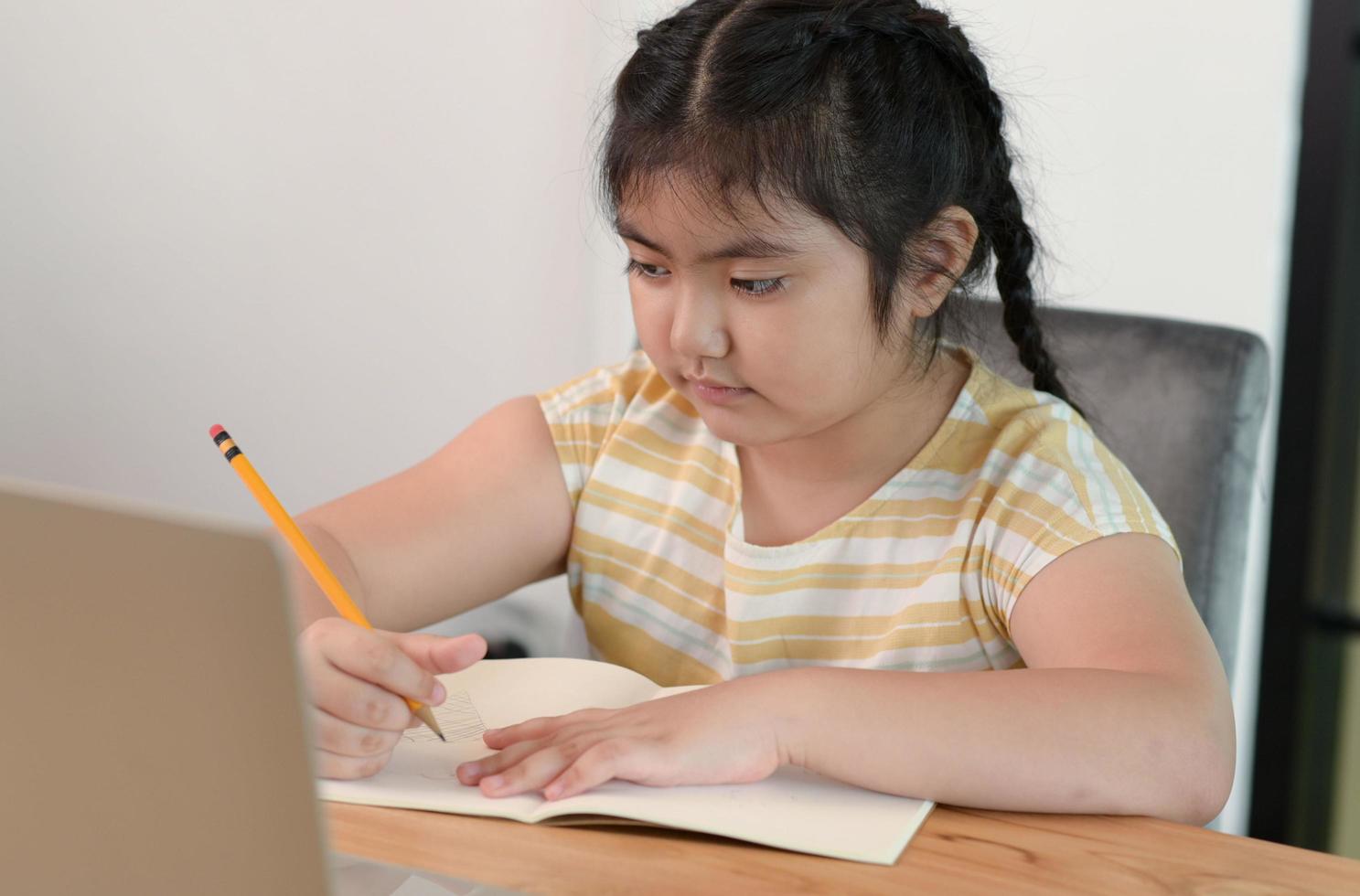 Aziatische meisjes studeren in bijles, studeren thuis online, meisjes zijn verveeld en moe van bijles. foto