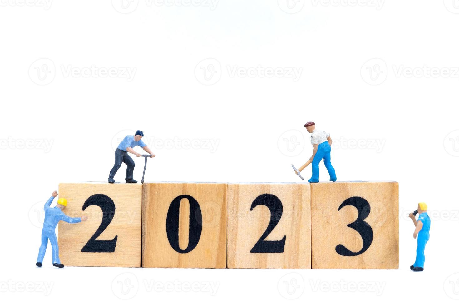 miniatuur mensen werknemer team maken nummer 2023 op houten blok foto