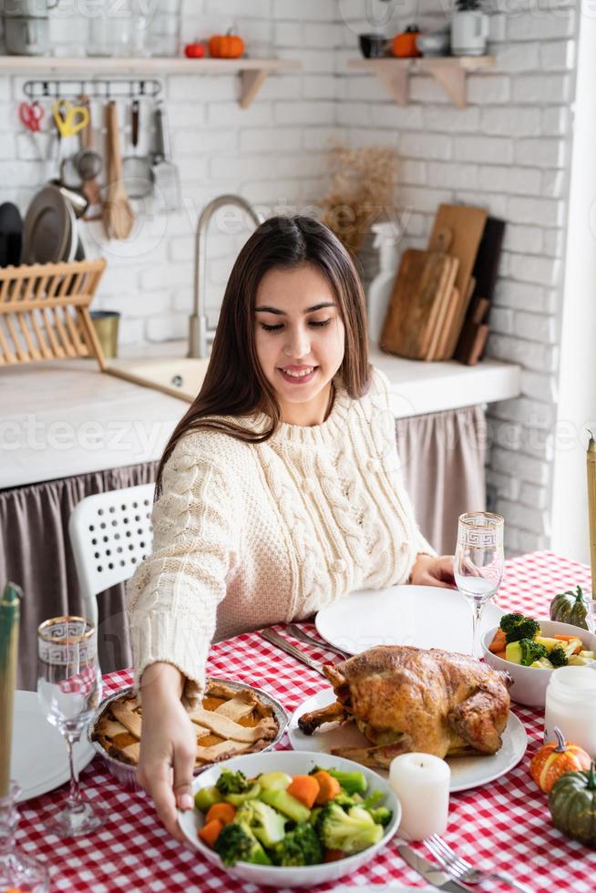 vrouw voorbereiding Thanksgiving diner thuis keuken, decoreren foto