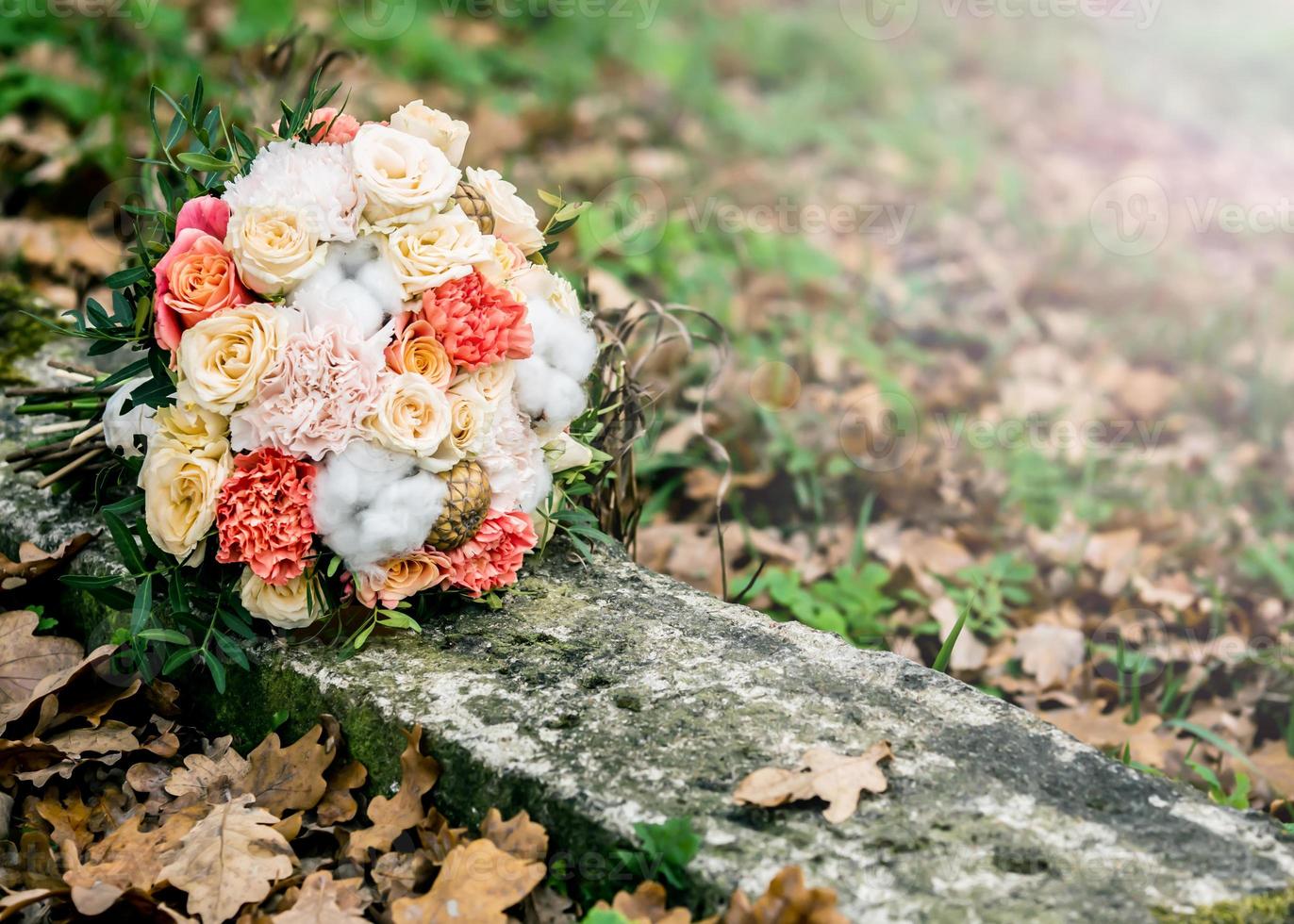 huwelijksboeket van verschillende bloemen die op de grond liggen foto