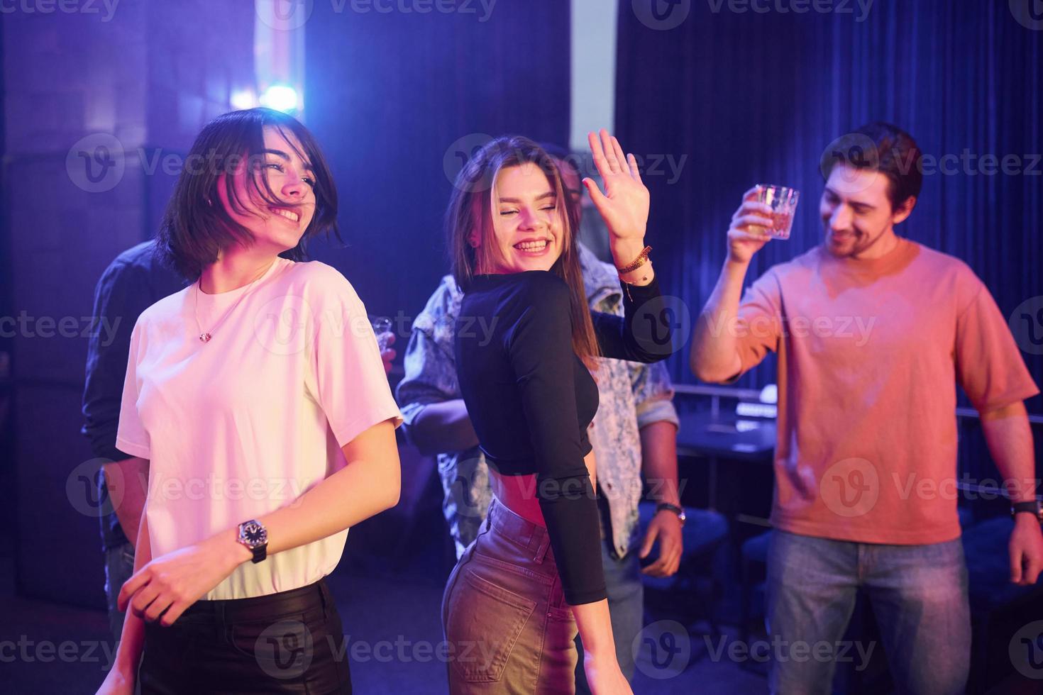 samen dansen. groep vrienden die plezier hebben in de nachtclub foto