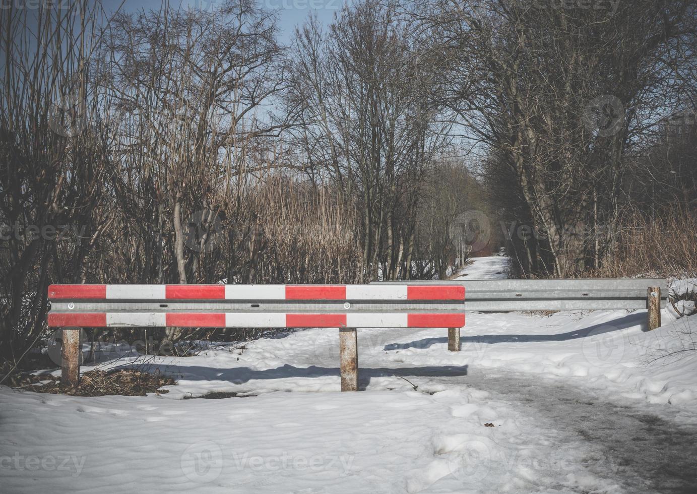 slagboom over een besneeuwde winterweg foto