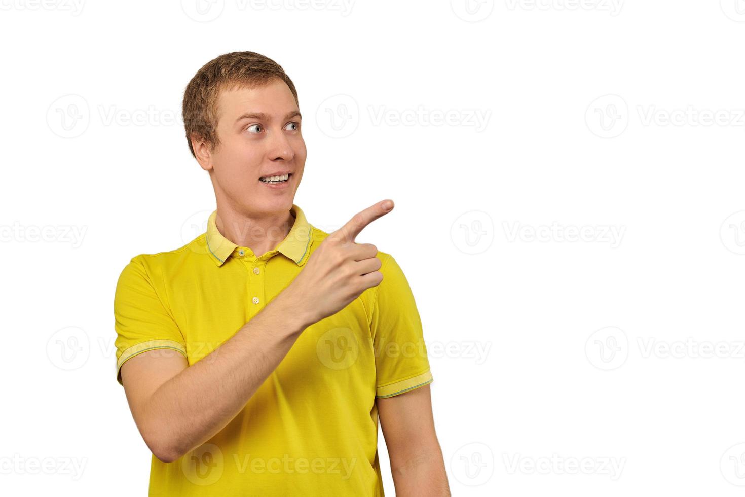 verraste man met grappig gezicht in fel geel t-shirt wijzende vinger naar rechts, witte achtergrond foto