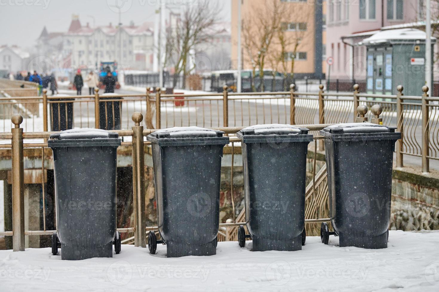 grijze vuilnisbakken, afvalcontainers buiten in de winter foto