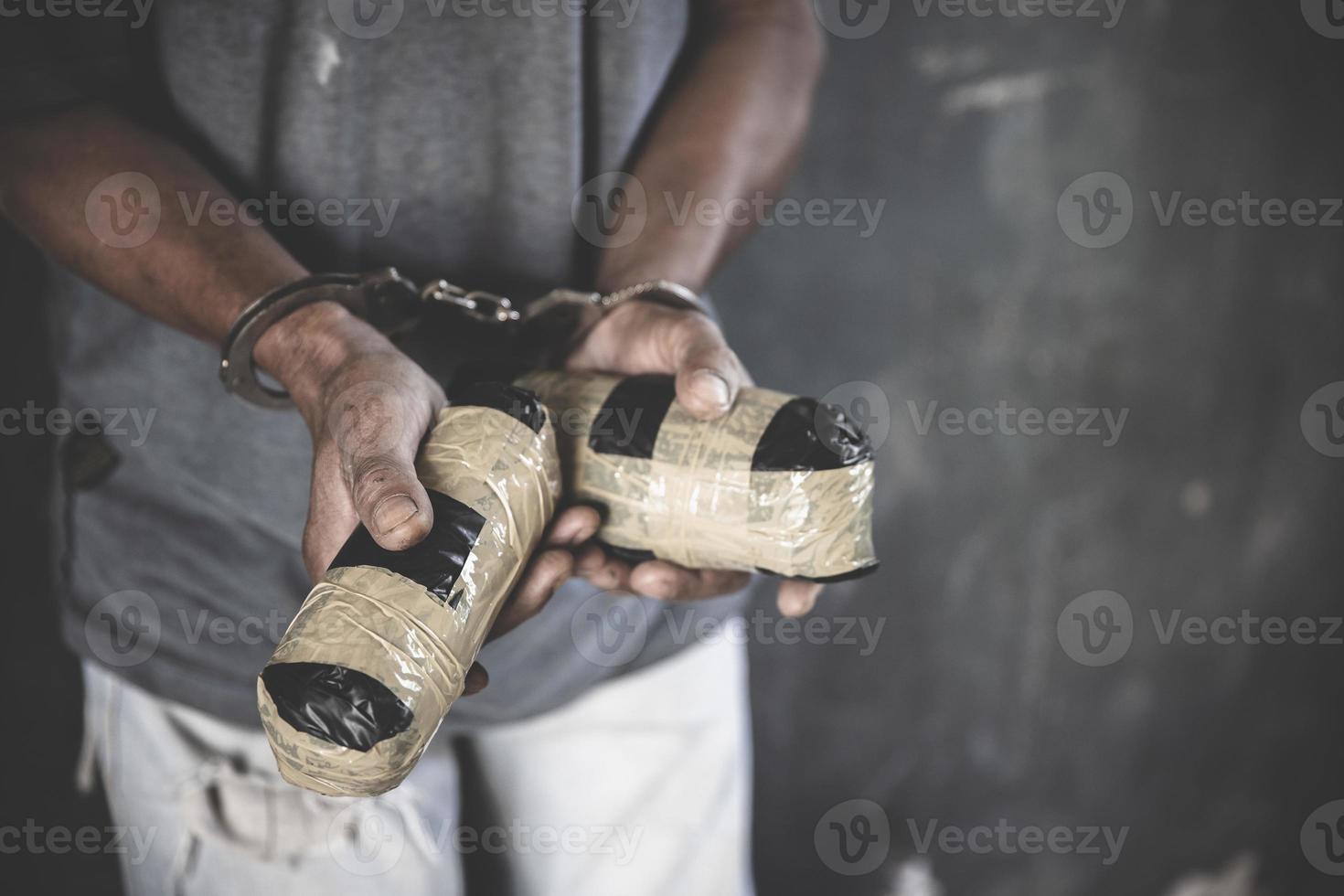 drugshandelaren werden gearresteerd samen met hun heroïne. politie arresteert drugshandelaar met handboeien. wet en politie concept, wereld anti-drugs dag, 26 juni, internationale dag tegen drugsmisbruik. foto