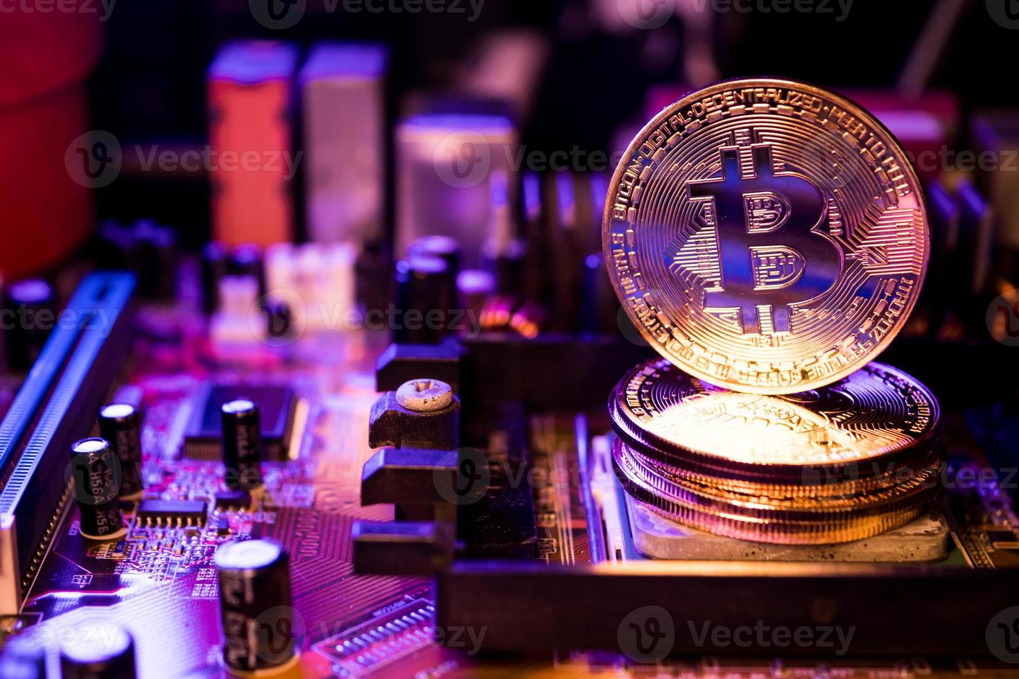 gouden munten met bitcoin-symbool op een moederbordcomputer. foto