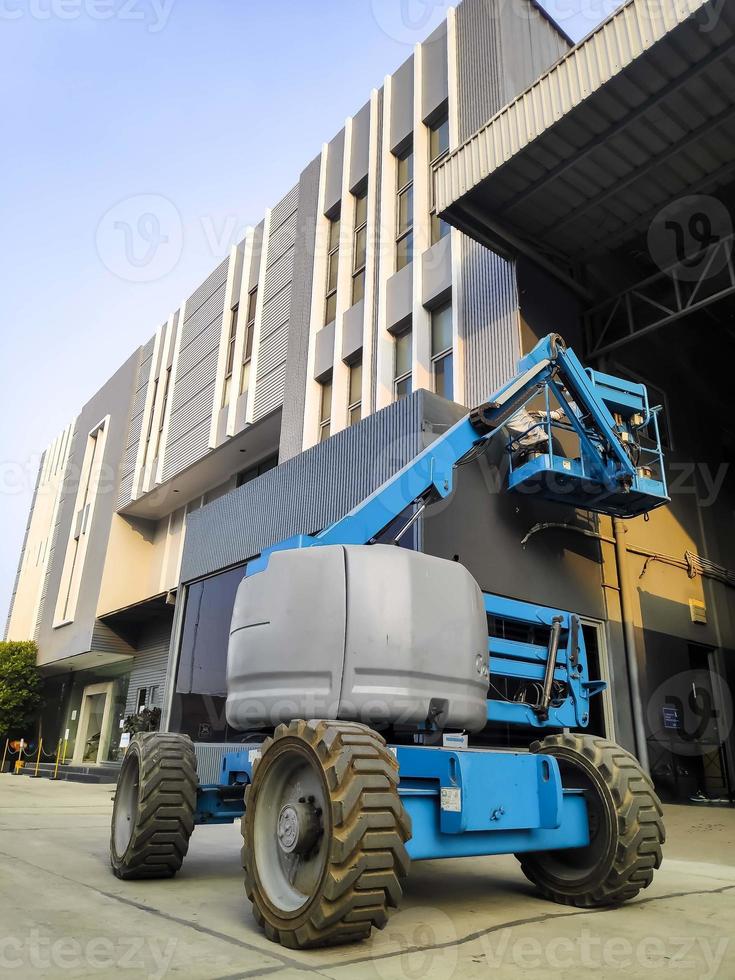 manlift kraan met platform hijsen naar het dak van een gebouw foto