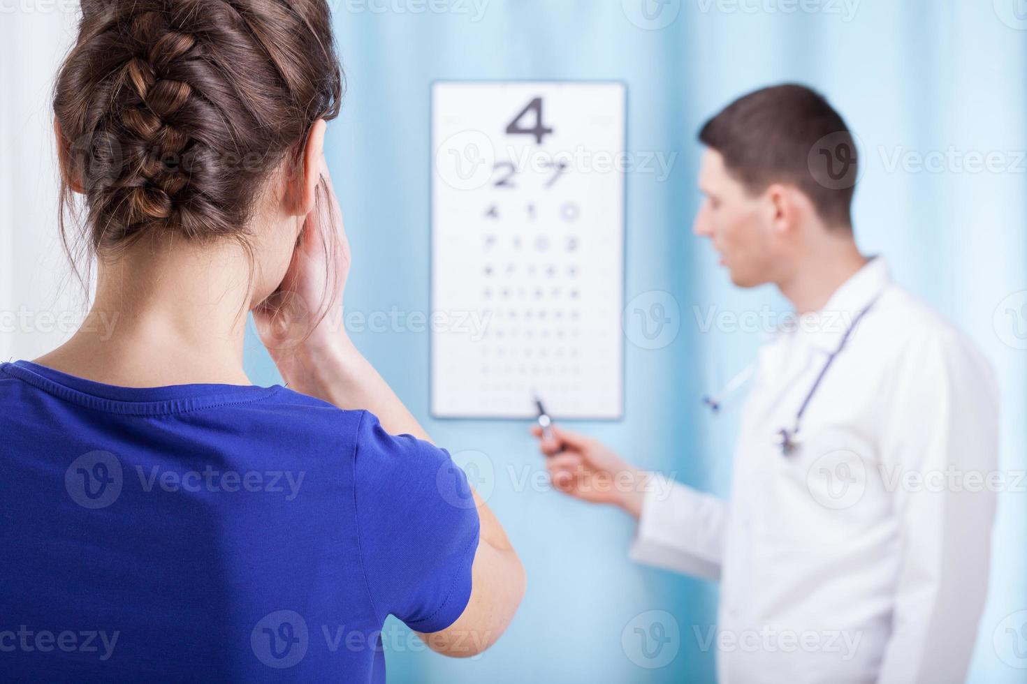 jonge oogarts voert oogonderzoek uit foto