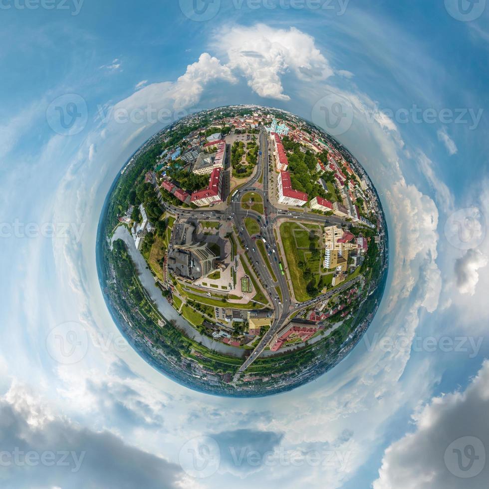 kleine planeet in de lucht met wolken met uitzicht op de oude stad, stedelijke ontwikkeling, historische gebouwen, kruispunt met brug over brede rivier. transformatie van bolvormig 360 panorama in abstracte luchtfoto. foto