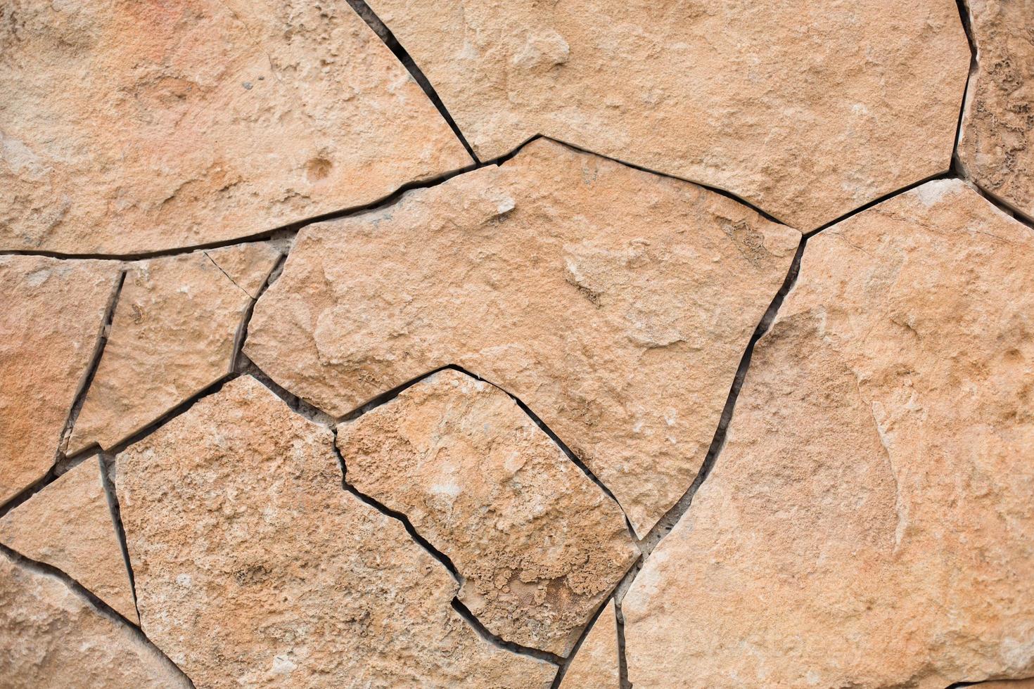 gemetselde muren van natuurlijke zandkleur. steen textuur close-up, bouw en mijnbouw achtergrond. foto