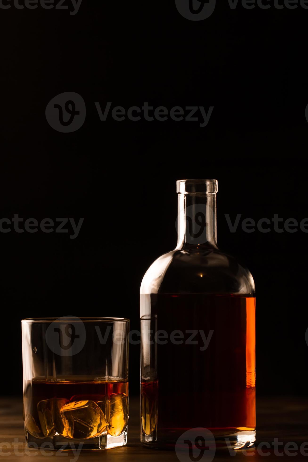 verontschuldiging Let op Baan glas whisky met ijs en fles op houten tafel. 851859 Stockfoto