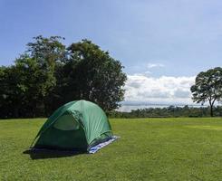 groene tent verspreid op het gras op de plek waar de tent zich verspreidt van de huai mae khamin-waterval, kanchanaburi, thailand. foto