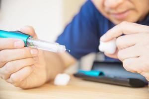 man bereidt insuline diabetische spuit voor injectie - mensen diabetische gezondheidszorg concept foto