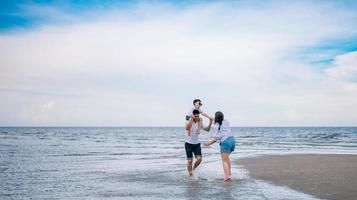 gelukkige familie die op het strand springt foto