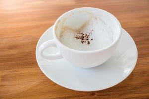 art latte koffie in een witte kop op houten tafel uit eten? foto