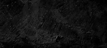 donkere zwarte stenen achtergrond. enge zwarte betonnen textuur. stenen muur achtergrond. foto