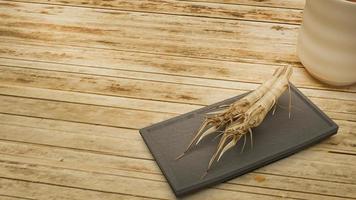 ginseng 3D-rendering in zwarte plaat op bamboe tafel voor medische inhoud. foto