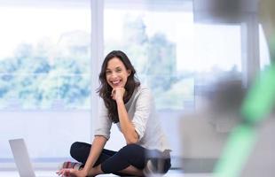 jonge vrouwen die laptopcomputer op de vloer gebruiken foto