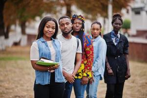 rij van groep vijf Afrikaanse studenten die samen tijd doorbrengen op de campus op het universiteitsterrein. zwarte afro-vrienden studeren. onderwijs thema. foto