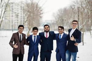 groep van vijf Indiase zakenman in pakken poseerde buiten in de winterdag in europa. foto