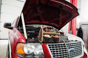 Amerikaanse suv auto voertuig reparatiewerkplaats met auto en gereedschap. auto onderhoud. foto