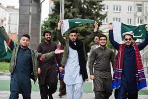 groep pakistaanse man met traditionele kleding salwar kameez of kurta met pakistaanse vlaggen. foto